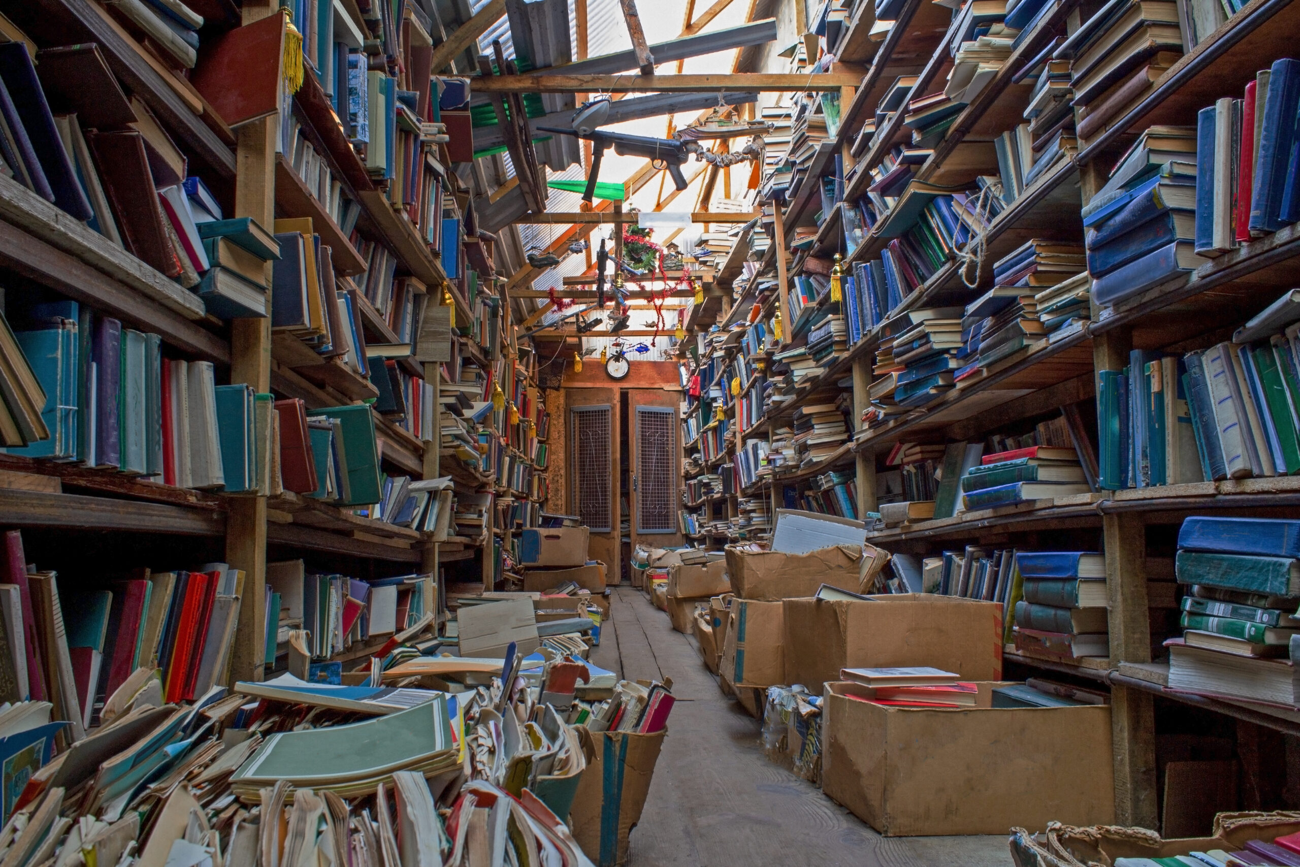 An old abandoned library. Book background. Books on the bookshelf. Knowledge in paper form